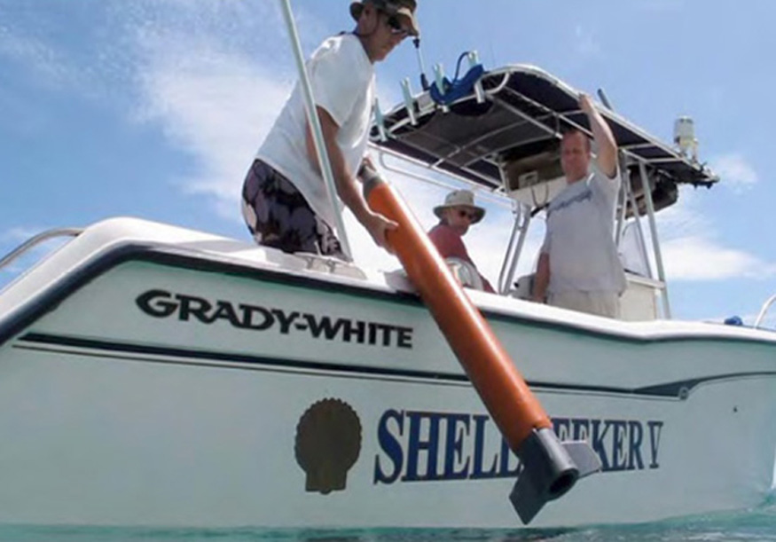 The Shell Seeker V, a 26-foot center-console, Grady-White employed for both survey and diving. Mr. Charles Consolvo, Board Memeber of the Trust, Project Manager of the investigation, and vessel owner is at the helm. Pictured is the magnetometer being deployed (courtesy of Erik Miles).